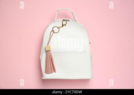 Backpack with leather keychain on pink background, top view Stock Photo