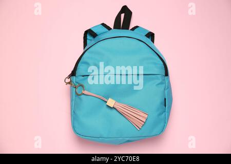 Backpack with leather keychain on pink background, top view Stock Photo