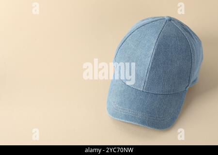 Stylish denim baseball cap on beige background. Mockup for design Stock Photo