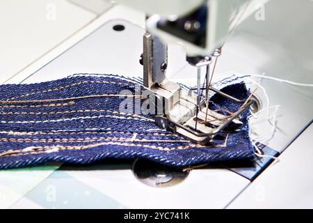 Two-needle sewing machine and piece of fabric Stock Photo