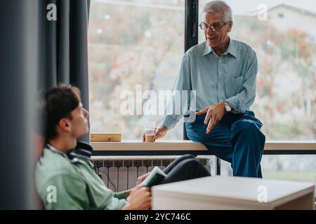 Professor engaging with students in a relaxed classroom setting Stock Photo