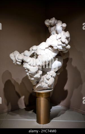 Eberly Minerals And Gems Gallery Sandstone Concretion Washington DC | WASHINGTON D.C., United States — A large sandstone concretion from Fontainebleau, France, forms a sculptural, cloud-like mass on display in the Eberly Family Gallery of Minerals and Gems at the Smithsonian National Museum of Natural History. The specimen shows how fine quartz cement binds sand grains together over time, producing solid rock from what was once loose sediment. Stock Photo