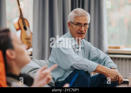 Senior professor engaging students in casual discussion session Stock Photo