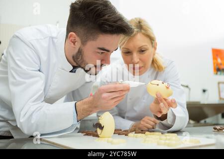 portrait of people working on easter eggs Stock Photo