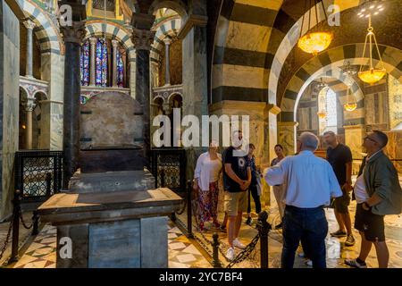 A tour group at the throne of Charlemagne in the Aachen Cathedral (UNESCO’s World Heritage Site) is the final resting place of Charlemagne in the old Stock Photo