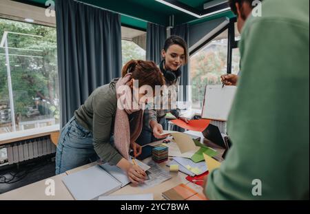 Students collaborating on school tasks in a modern classroom setting Stock Photo