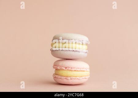 stack of macaroons on plain pink background, tasty almond dessert on bright pink background Stock Photo