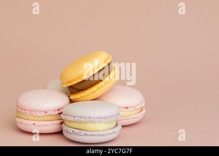 stack of macaroons on plain pink background, tasty almond dessert on bright pink background Stock Photo