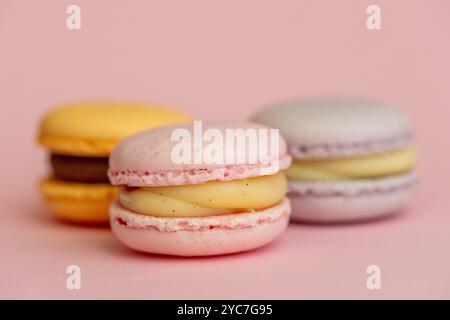 stack of macaroons on plain pink background, tasty almond dessert on bright pink background Stock Photo