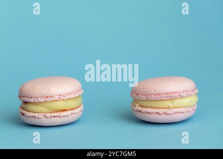 stack of macaroons on plain pink background, tasty almond dessert on bright pink background Stock Photo