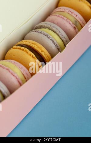 stack of macaroons on plain pink background, tasty almond dessert on bright pink background Stock Photo