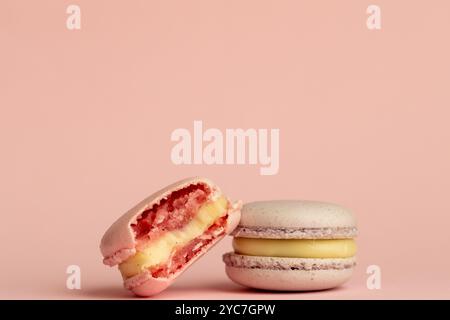 stack of macaroons on plain pink background, tasty almond dessert on bright pink background Stock Photo