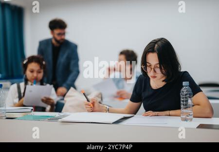 Students engaging in classroom activities with professor guidance Stock Photo
