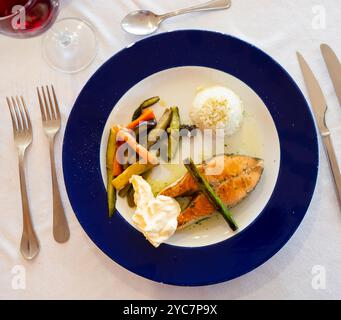 Nice serving of seared salmon with rice and vegetables on side Stock Photo