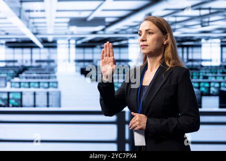 Engineer in server hub using AR technology checking hardware after installing storage units. Data center worker using augmented reality to do maintenance after replacing mainframes components Stock Photo
