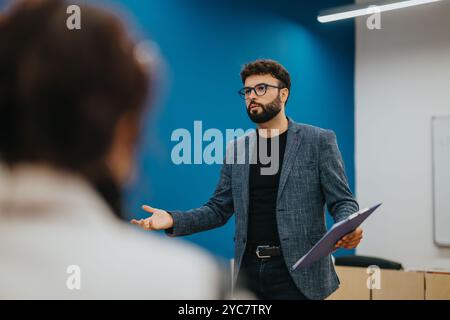 Professor assists students during a dynamic classroom session Stock Photo