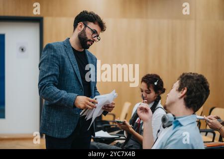 Engaged students consulting professor during an interactive class discussion Stock Photo