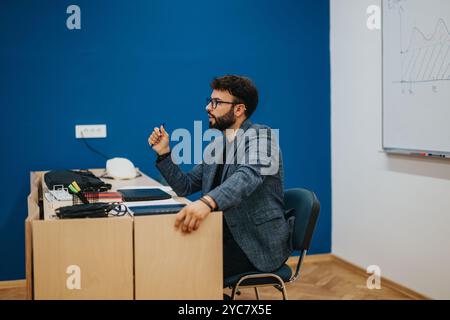 Confident teacher in classroom engaging with students Stock Photo