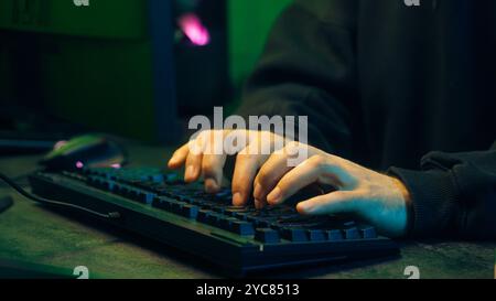Programmer man keyboard computer typing hacker internet networking online professional software cyber tech security pc web coding browsing gaming Stock Photo