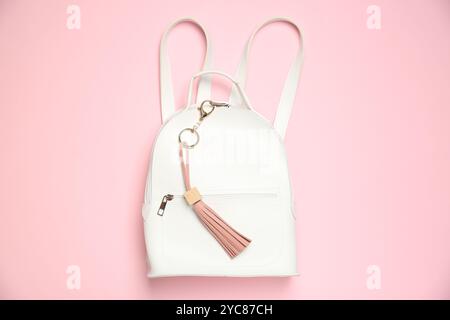 Backpack with leather keychain on pink background, top view Stock Photo