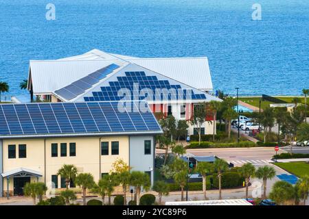 Photovoltaic panels on solar rooftops of Florida commercial buildings for producing clean ecological electrical energy. Renewable electricity with zer Stock Photo