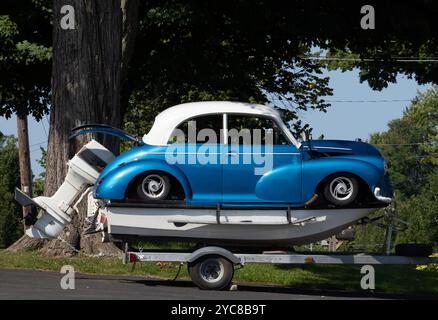 An old car acts as cabin on a small boat Stock Photo