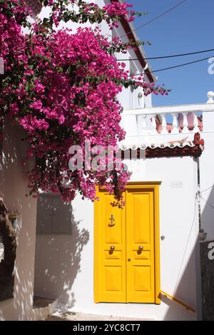 The yellow door of a villa in the old town of Hydra, Greece Stock Photo