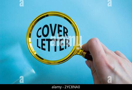 Cover Letter symbol. Concept word Cover Letter with Magnifying glass. Businessman hand. Beautiful blue background. Business and Cover Letter concept. Stock Photo