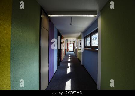 Sunlit Corridor with Colorful Walls Stock Photo