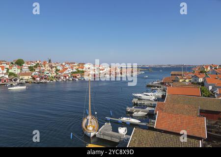 View over Fiskebackskil an old seaside village on the Swedish west coast, with Lysekil city in the background Stock Photo