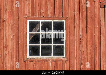 Window on a red weathered barn Stock Photo