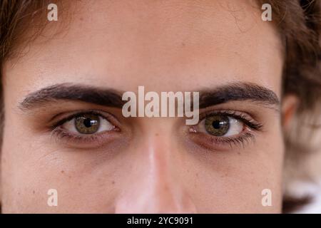 Close-up of man's green eyes gazing intently, capturing deep emotion and focus Stock Photo