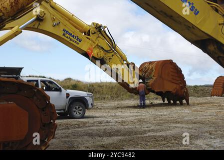 WESTPORT, NEW ZEALAND, MARCH 11, 2015: An engineer works on the bucket of a 200 ton excavator at Stockton open cast coal mine on March 11, 2015 near W Stock Photo