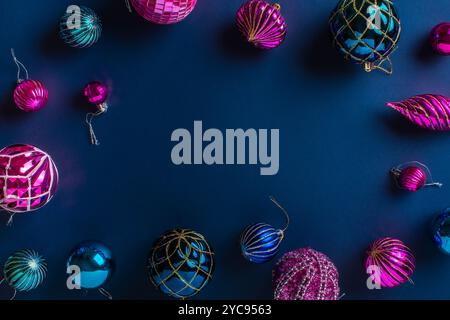 Christmas frame made of pink and blue Christmas balls on a dark blue background. Flat layout, top view, free space for copying. Stock Photo