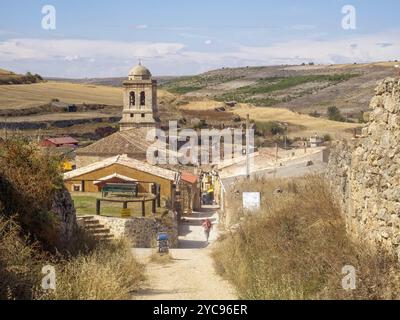 Belltower of the 16th century parish church of the Conception tucked down in a small valley of the Meseta, Hontanas, Castile and Leon, Spain, Europe Stock Photo