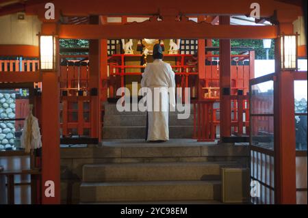 24 Dec 2017, Kyoto, Japan, Asia, A Shinto priest prays in a temple on the way to Fushimi Inari-Taisha, a Shinto shrine in the Fushimi district of Kyot Stock Photo