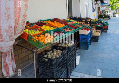 Street stalls selling fresh fruit and vegetables in Mangalem district of Berat, Albania. Cherries, peaches, apples, plums, potatoes, cucumbers, melons Stock Photo