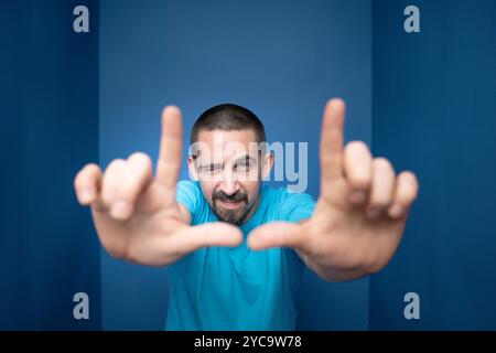 Young man doing frame using hands and fingers, isolated over purple background Stock Photo