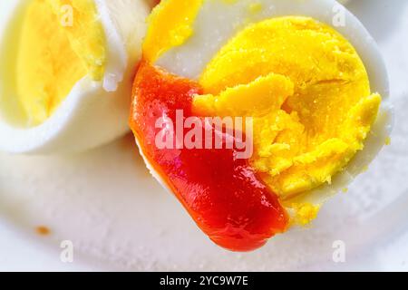 Boiled egg with ketchup and salt. Stock Photo