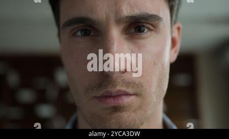 Moving shot portrait young pensive Caucasian male business man thoughtful guy businessman depressed patient client worker sad entrepreneur looking at Stock Photo