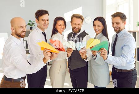 Happy business people holding paper planes planning travel or rejoicing in successful cooperation Stock Photo