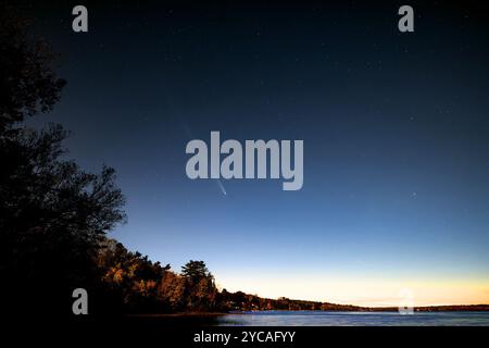 Comet C 2023 A3 (Tsuchinshan-ATLAS) an hour after sunset over the Ottawa river near Ottawa, Canada October 16, 2024 Stock Photo