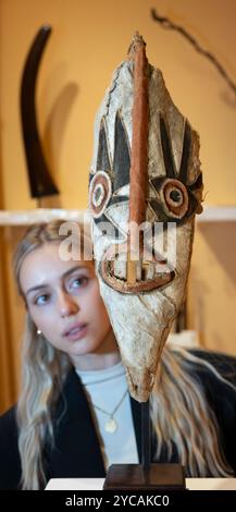 Berkeley Square, London, UK. 22nd Oct, 2024. LAPADA (the largest professional trade association of art & antiques dealers in the UK) art and antique collections under one roof in a decorated marquee, running from 23-27 October in Berkeley Square. Highlights include: Ethnic masks and carvings. Credit: Malcolm Park/Alamy Live News Stock Photo