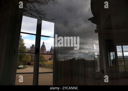 Aschaffenburg, Germany. 22nd Oct, 2024. Johannisburg Castle can be seen behind two windows of a pavilion, in the front window of which the cloudy sky is reflected. Credit: Karl-Josef Hildenbrand/dpa/Alamy Live News Stock Photo