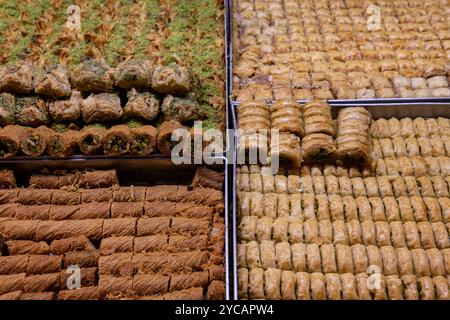 Trays of baklava, a layered pastry dessert made of filo pastry, filled with chopped nuts, and sweetened with syrup or honey, on sale in the Machane Ye Stock Photo