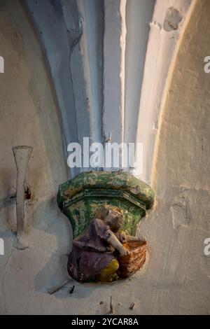 Berck, France - 09 20 2024:  Detail inside Saint John Church of drop of an arch made up of a sculpture of a scene from daily life Stock Photo