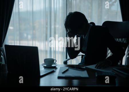 Stressed businessman, sleepy man working in his office, sat at his computer, feeling weight of his job and the demands of his business. person, work, Stock Photo