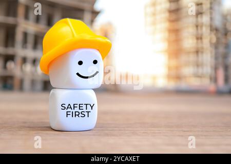 White cubes with hard hat and text SAFETY FIRST. Copy space for text. Stock Photo