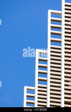 Modern architectural abstract. Geometric design against clear blue sky background. Space for text. Stock Photo