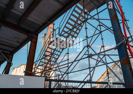A minimalist urban scene showcasing a construction site with a towering crane. Highlights the intersection of infrastructure, development, and modern Stock Photo